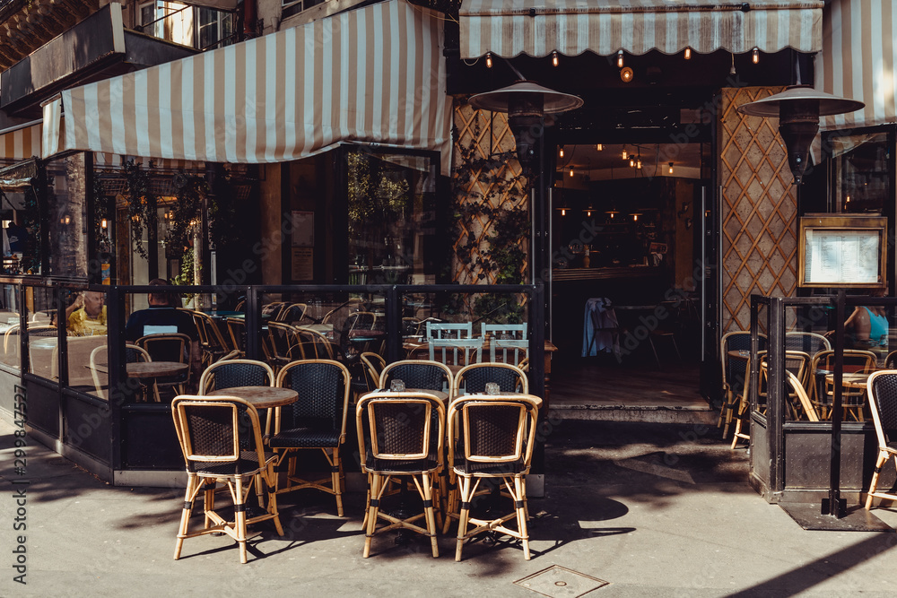 Cozy street with tables of  cafe in Paris, France - obrazy, fototapety, plakaty 