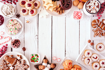 Poster - Christmas sweets and cookie frame. Top view table scene over a white wood background with copy space. Holiday baking concept.