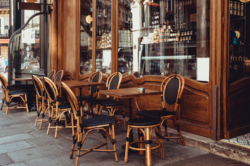 Wall Mural - cozy street with tables of cafe in paris, france