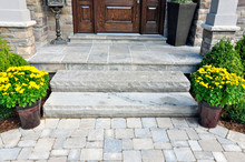 Flagstone Applied To The Original Concrete Veranda, Natural Stone Steps, And Paver Walkway All Provide A Beautiful, Fresh Landscape Update To This Stately Home.