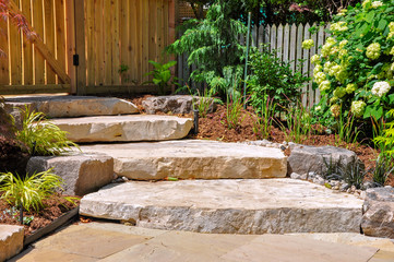 Huge natural stone slab steps create a beautiful urban front garden, and a safe transition to a hidden upper garden.