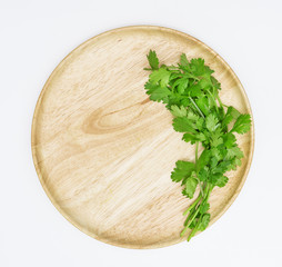 Wall Mural - coriander on wooden dish,isolated on white background,top view