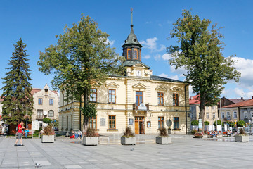 NOWY TARG, POLAND - SEPTEMBER 12, 2019: City hall building and fountain in front of it at the market square