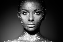 Fashion Model Woman In Bright Sparkles And Lights Posing In Studio. Portrait Of Beautiful Sexy Woman. Art Design Glitter Glowing Make Up. Black And White Photography