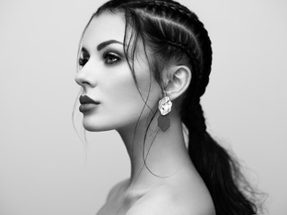 Wall Mural - Brunette girl with perfect makeup. Beautiful model woman with curly hairstyle. Care and beauty hair products. Lady with braided hair. Model with jewelry. Black and white photo