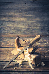 Closeup of rustic chisel and planer in a carpentry workshop