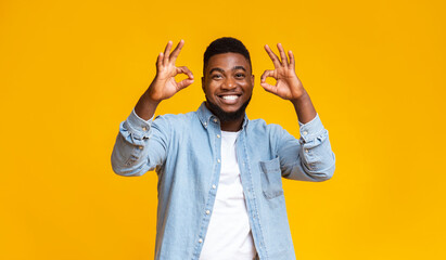 Wall Mural - Optimistic african american guy showing ok gesture with both hands