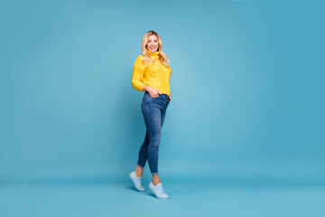 Poster - Full length photo of amazing blond lady slim perfect shapes street autumn look hold hands in pockets wear knitted yellow pullover jeans isolated blue color background