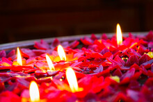 Candles Make Like Flowers Burned And Flating On Water Surface In Pot