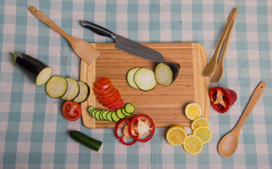 wooden plate with vegetables on a table