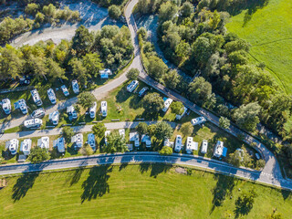 aerial view of campground in rural area in europe with many caravans. concept of adventure and outdo