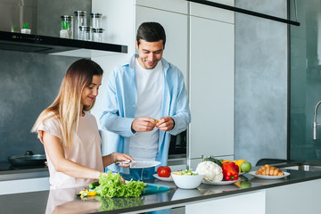 Young couple cooking a vegetarian breakfast in the morning in a bright kitchen