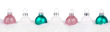 Christmas Border Of Dusty Rose, White And Teal Ornaments Resting In Snow Isolated A White Background