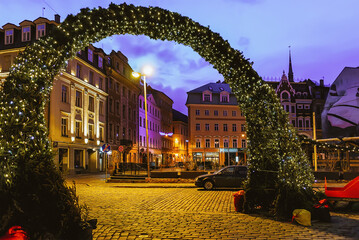 Arch at Christmas market on Dome Square in Riga evening