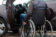 © Gustavo Muñoz - A man in a wheelchair trying to get into the driver's seat of a car