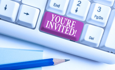 Text sign showing You Re Invited. Business photo text make a polite friendly request to someone go somewhere White pc keyboard with empty note paper above white background key copy space