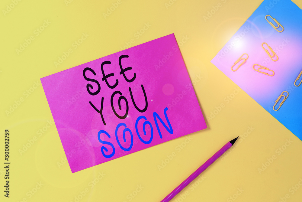Writing note showing See You Soon. Business concept for used for saying goodbye to someone and going to meet again soon Blank paper sheets message pencil clips binder plain colored background