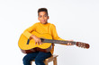 © luismolinero - African American boy  with guitar over isolated white background