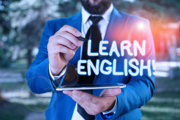 Poster - Conceptual hand writing showing Learn English. Concept meaning gain acquire knowledge in new language by study Businessman in blue suite stands with mobile phone in hands