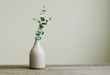 Eucalyptus branch in a vase on the table with copy space