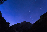 Fototapeta Kosmos - Night sky with stars at Dolomites mountains, Italy