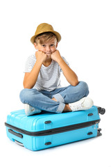 Poster - Cute little boy with suitcase on white background