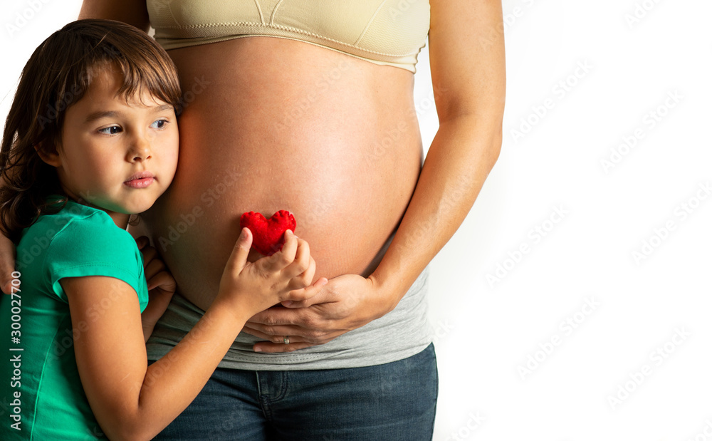 Little girl want to hear her sister hearte beat, listening her mother ...