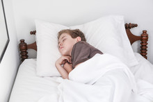 Young Boy Sleeping In Bed