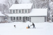 © soupstock - Man using a snowblower to clear his sidewalk and driveway