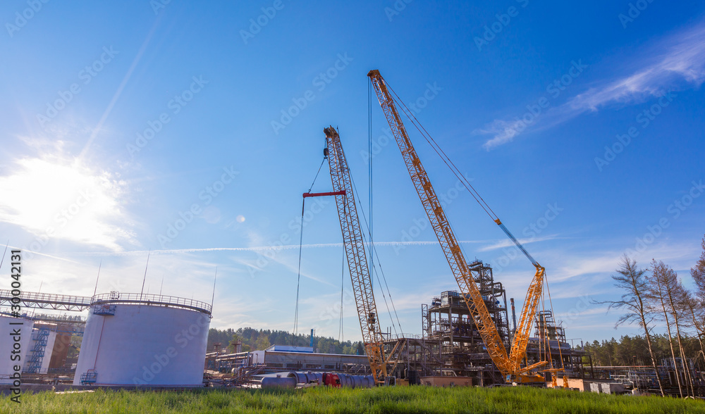 MOSCOW, RUSSIA, 08.2018: The construction of an oil refinery, near Moscow. industrial cranes (LIEBHERR), construction and installation of components of an oil refinery in near Moscow.