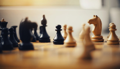 Wooden chess pieces on the chessboard.