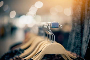 Shopping in store. Clothes on hangers in shop for sale