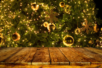 Wall Mural - beautiful christmas tree backdrop and lights with top of empty wood table. ready for your product di