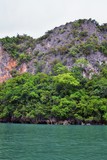 Fototapeta  - Island, Ocean views near Phuket Thailand with Blues, Turquoise and Greens oceans, mountains, boats, caves, trees resort island of phuket Thailand. Including Phi Phi, Ko Rang Yai, Ko Li Pe and other is