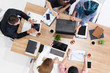 © InfiniteFlow - Top view of businessman executive in group meeting with other businessmen and businesswomen in modern office with laptop computer, coffee and document on table. People corporate business team concept.