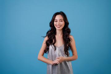 Wall Mural - woman in silver dress isolated over blue