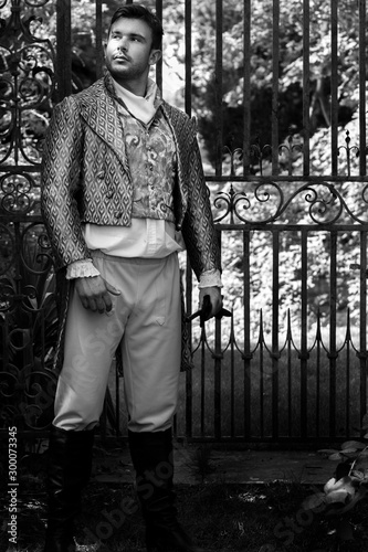 Photographie Portrait of handsome gentleman dressed in vintage costume standing in stately ho