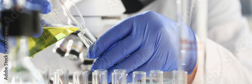Fotografía A male chemist holds test tube of glass in his hand