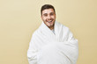 © Anatoliy Karlyuk - Cheerful happy energetic young male with bristle posing isolated wrapped in white blanket smiling broadly feeling overjoyed and refreshed after good sleep, ready for new day, plans and goals
