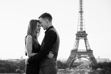 Black And White Photo, Smiling Couple In Love Near The Eiffel Tower. Romantic Date, Honeymoon In Paris