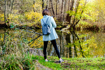 Girl taking pictures of nature in the autumn forest