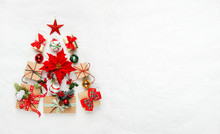 Christmas Tree Made From Christmas Gifts And Decorations On White Background. Creative Winter Holiday Concept. Flat Lay.