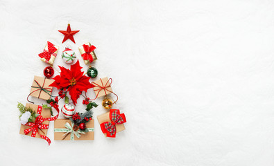 christmas tree made from christmas gifts and decorations on white background. creative winter holida