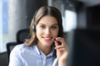 © ty - Female customer support operator with headset and smiling.