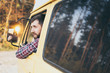 © oleksii.leonov - Caucasian man looking out of the window of his campervan