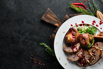 Stuffed duck with cranberry sauce. Restaurant dishes. Top view. Free copy space.