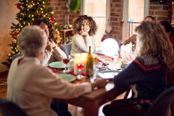 Beautiful group of women smiling happy and confident. Eating roasted turkey celebrating christmas at home