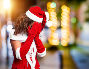 Canvas Print - Middle age woman wearing Santa Claus costume with sad expression covering face with hands while crying. Depression concept.