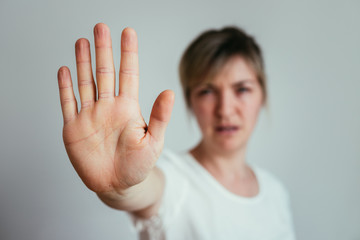 Defense or stop gesture: Girl hand with stop gesture