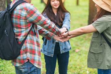 Canvas Print - Closeup image of people putting their hands together in the outdoors